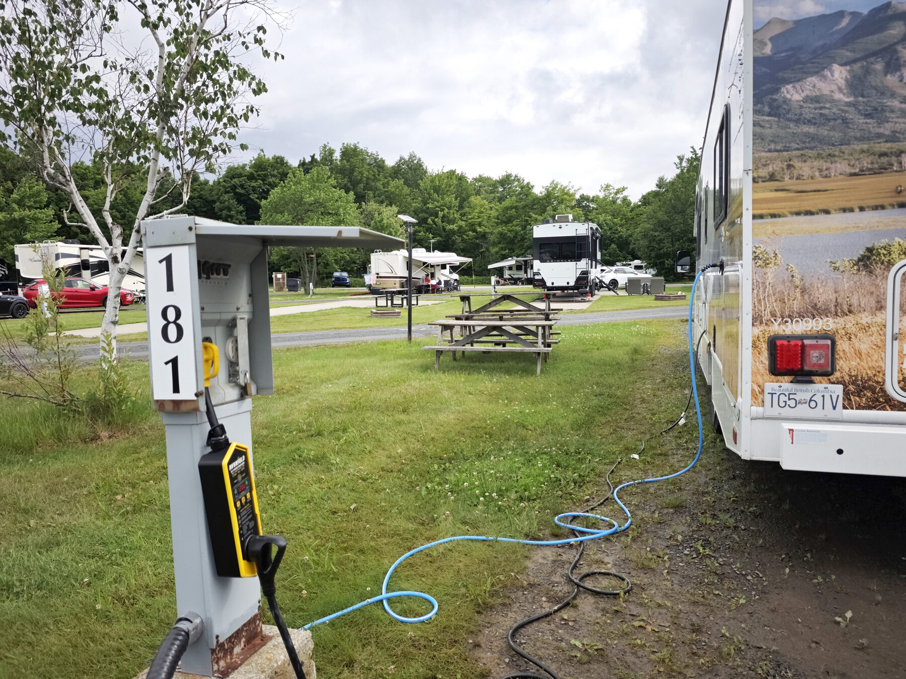RVShield connected to a numbered campground pedestal beside a motorhome
