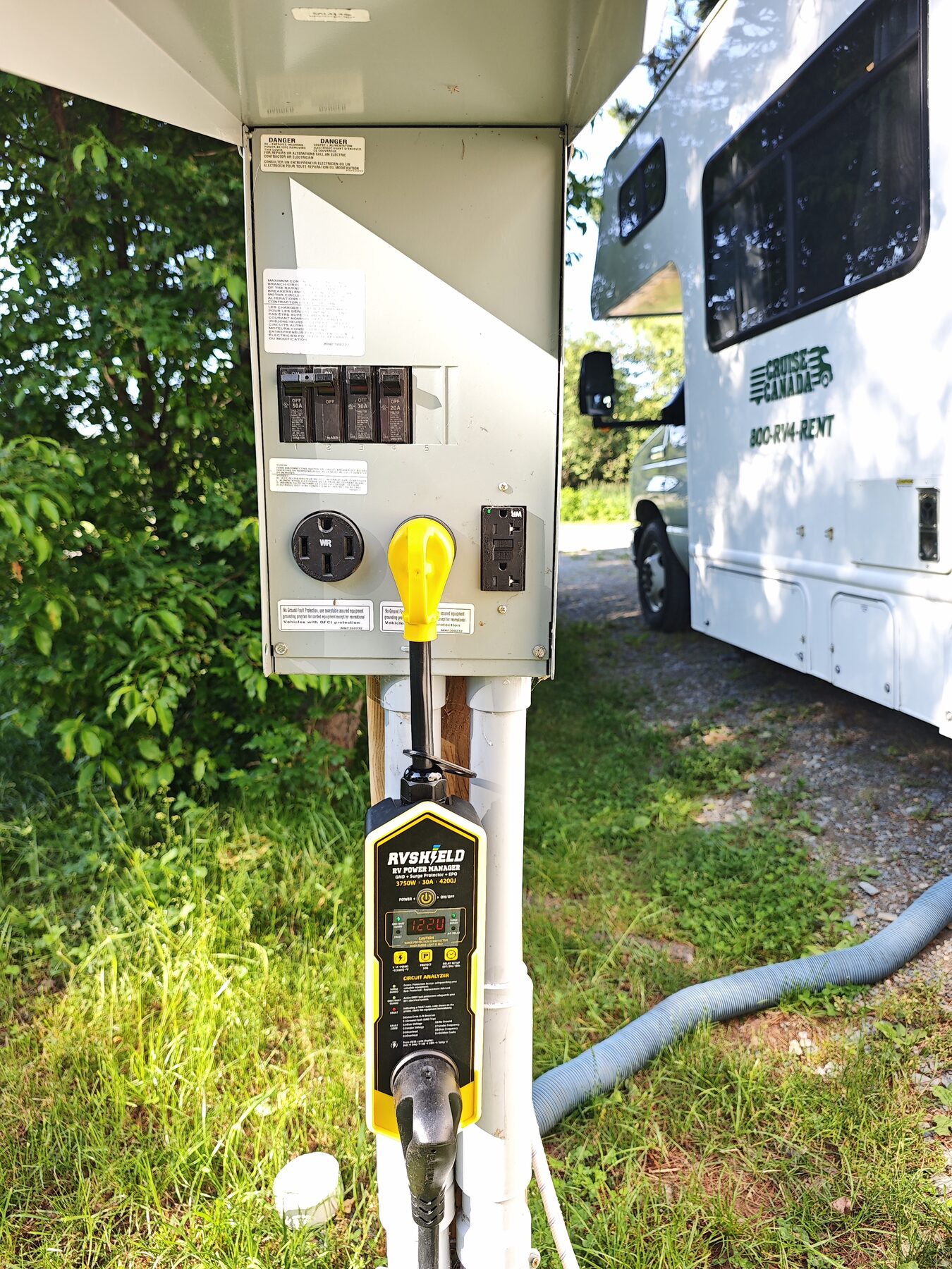 Close view of RVShield operating on a campground pedestal beside an RV
