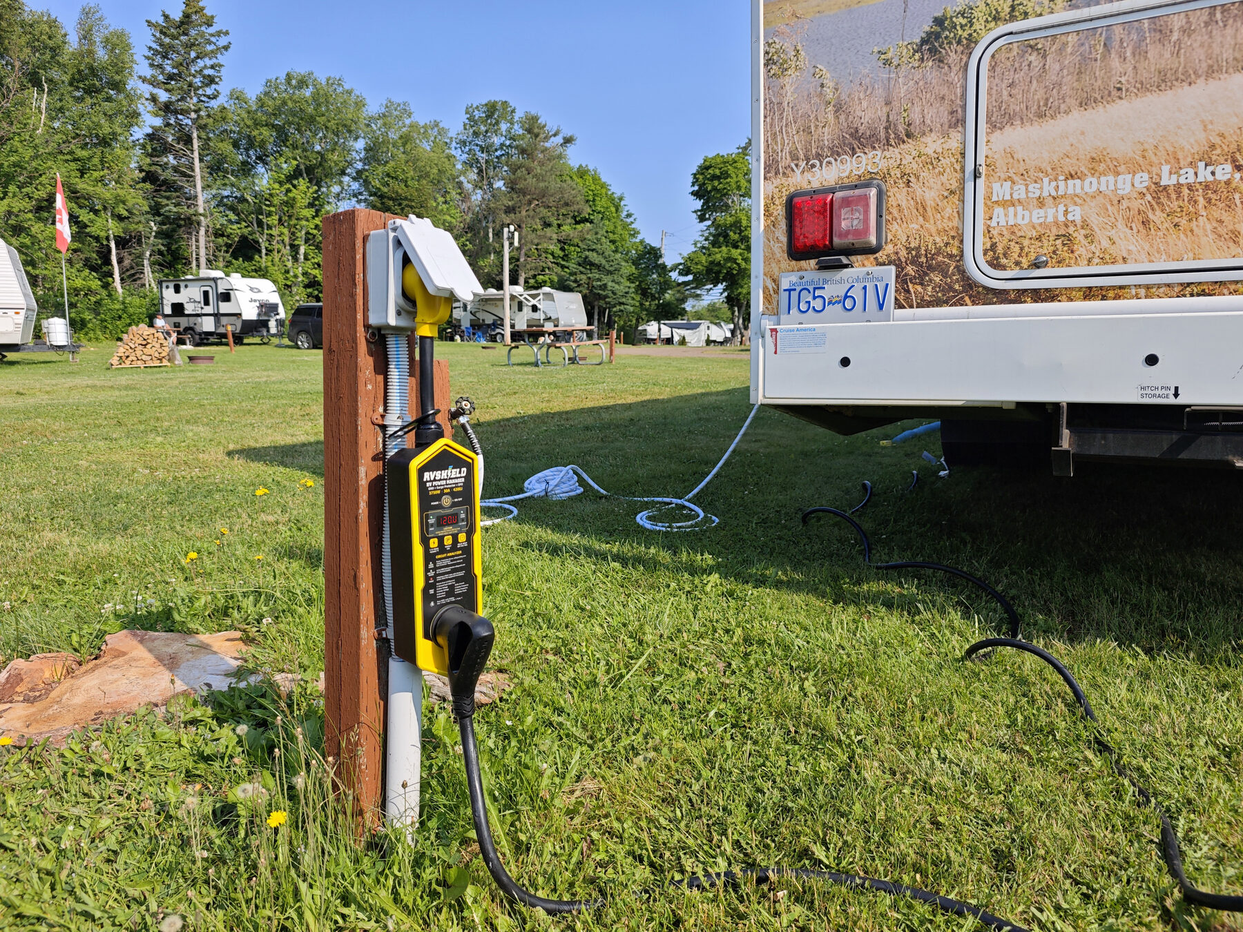 RVShield connected between a lakeside campground pedestal and a motorhome